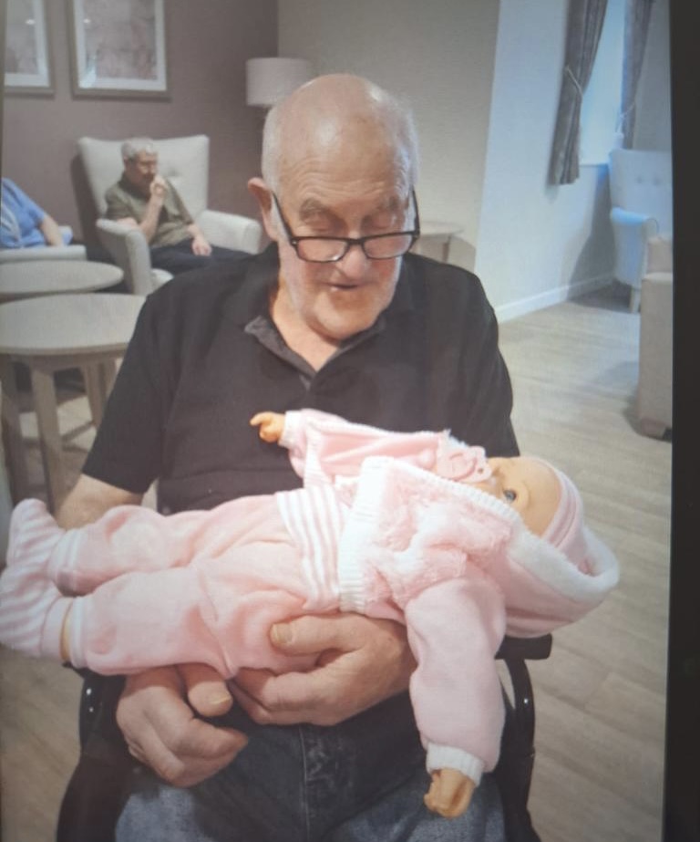 Resident holding baby doll 