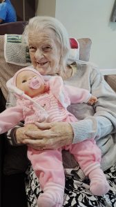 Resident holding a baby doll